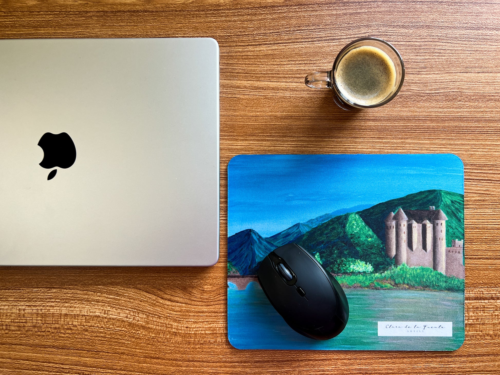 Scotland mousepad inspired in Scottish Eilean Donan castle in an office setting with a laptop and coffee