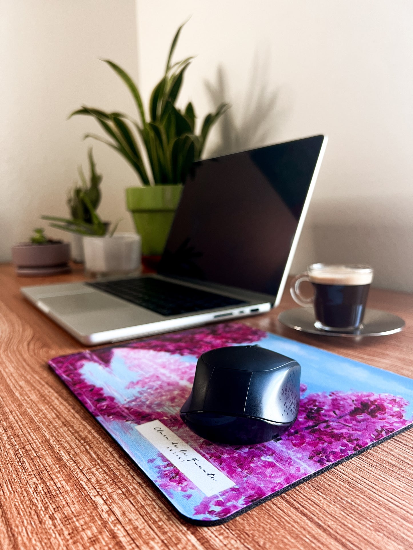 Cherry Blossom art mousepad with a mouse on a home office setting with plants and coffee