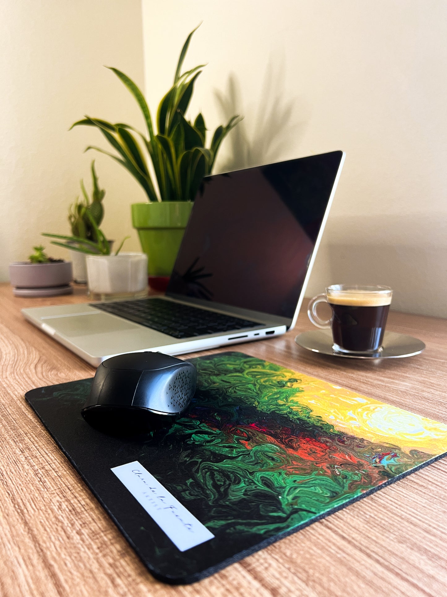 Amazonas Mousepad with mouse in a home office setting with plants, laptop and coffee